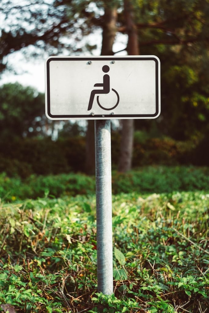 a handicapped sign in the middle of a field